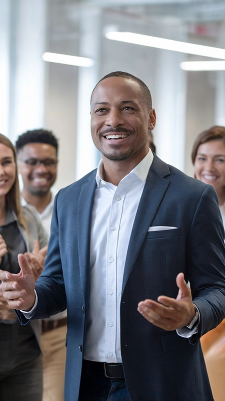 Confident executive smiling and engaging with colleagues, symbolizing leadership success and team collaboration, ideal for executive leadership care and coaching services.